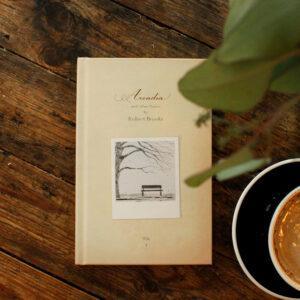 Hardcover poetry book by Robert Brooks styled in a cozy cafe setting, perfect for literary enthusiasts enjoying coffee and inspirational reading moments.
